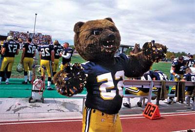 UNC Mascot with poms on football sidelines during game